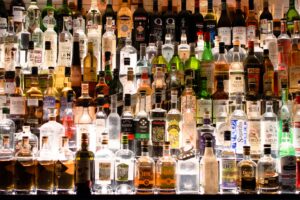 assorted liquor, wines, and whisky on display
